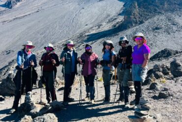 Kilimanjaro for Beginners – first-time female climbers posing with trekking poles on the Lemosho Route during their Mount Kilimanjaro adventure.