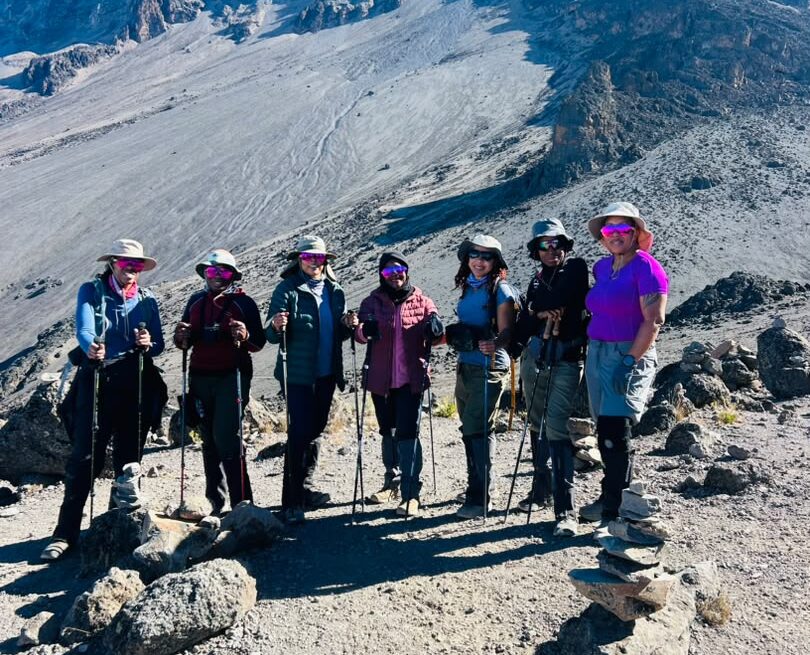 Kilimanjaro for Beginners – first-time female climbers posing with trekking poles on the Lemosho Route during their Mount Kilimanjaro adventure.