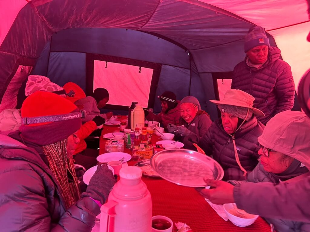 Kilimanjaro climbers enjoying quality meals together inside a mountain tent