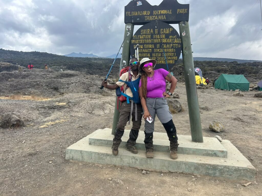 Female traveler with an expert Kilimanjaro mountain guide