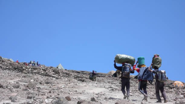 6-Day Umbwe Route Cost – porters carrying climbing equipment to Barafu Camp on Mount Kilimanjaro