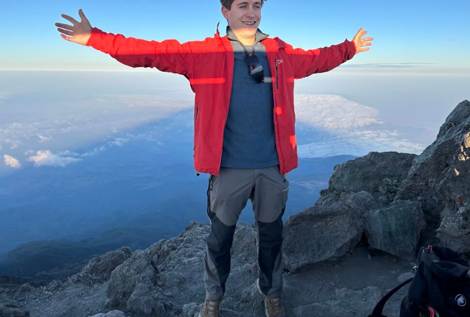 Mount Meru Trekking Tour – Hiker Celebrating on Mount Meru