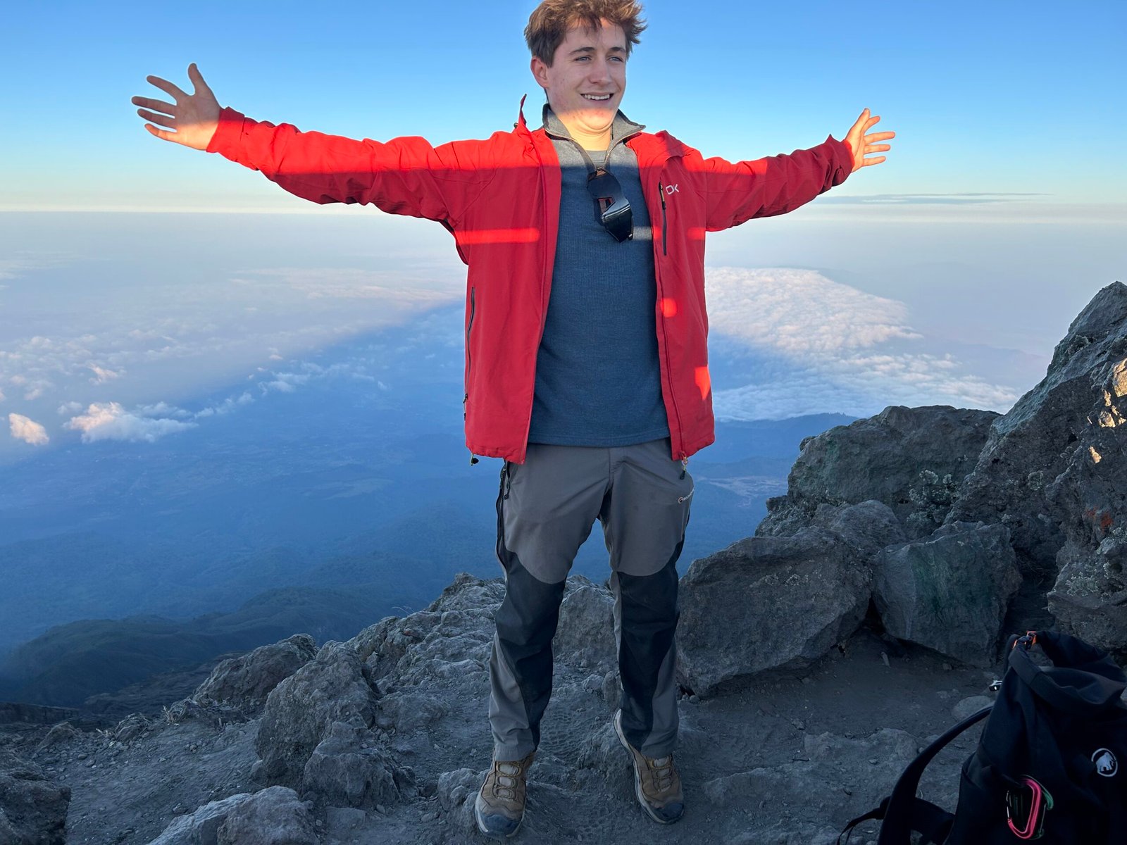 Mount Meru Trekking Tour – Hiker Celebrating on Mount Meru