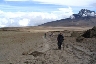 Trekkers hiking toward Mount Kilimanjaro along the Rongai Route in Tanzania